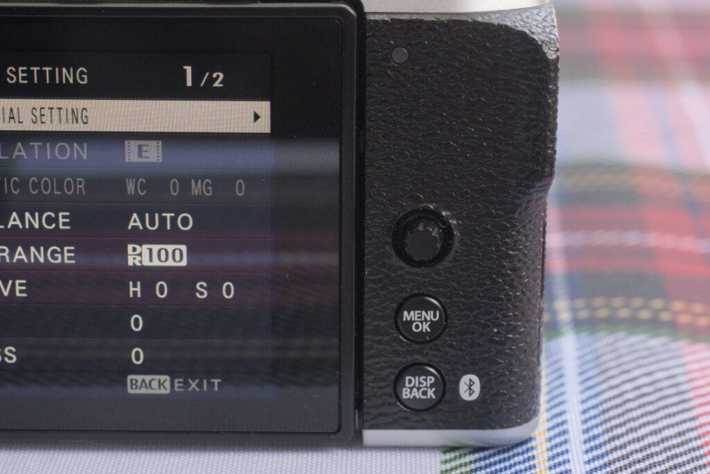 Back of the Fujifilm X-M5. To the left, the screen and to the right the rear control buttons: DISP/BACK, MENU/OK and the multi directional joystick.